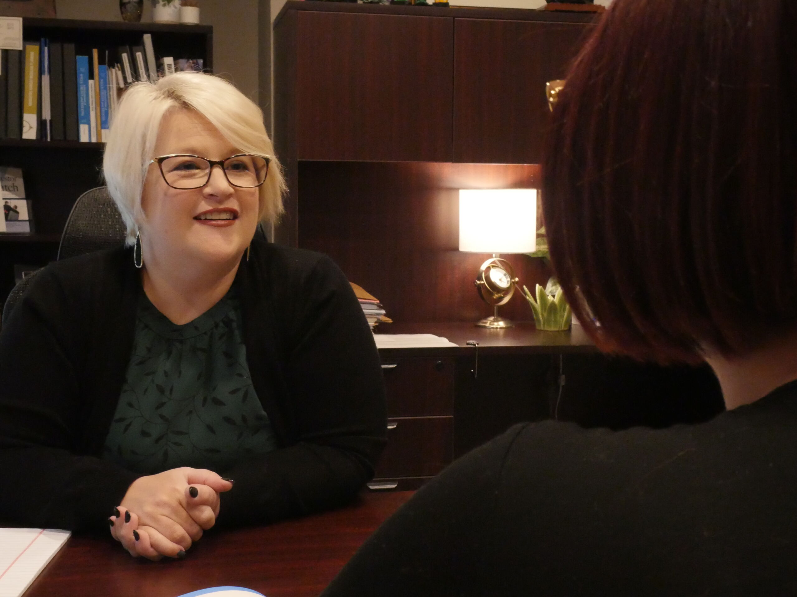 a paralegal sitting with a client